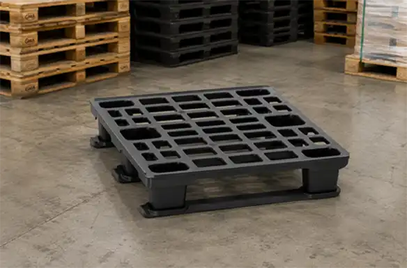 Black plastic pallet staged on a warehouse floor